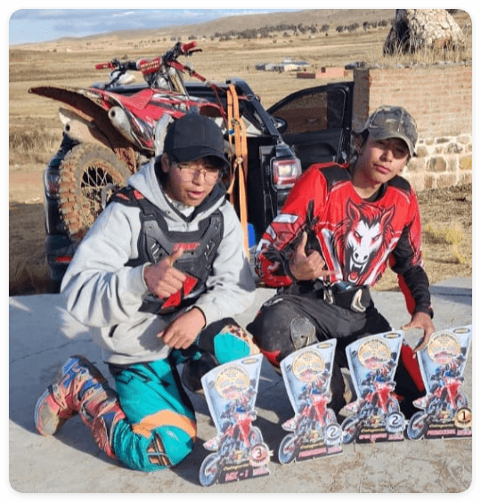 Bolivian motocross riders sharing their SANLSANCK custom racewear after an event