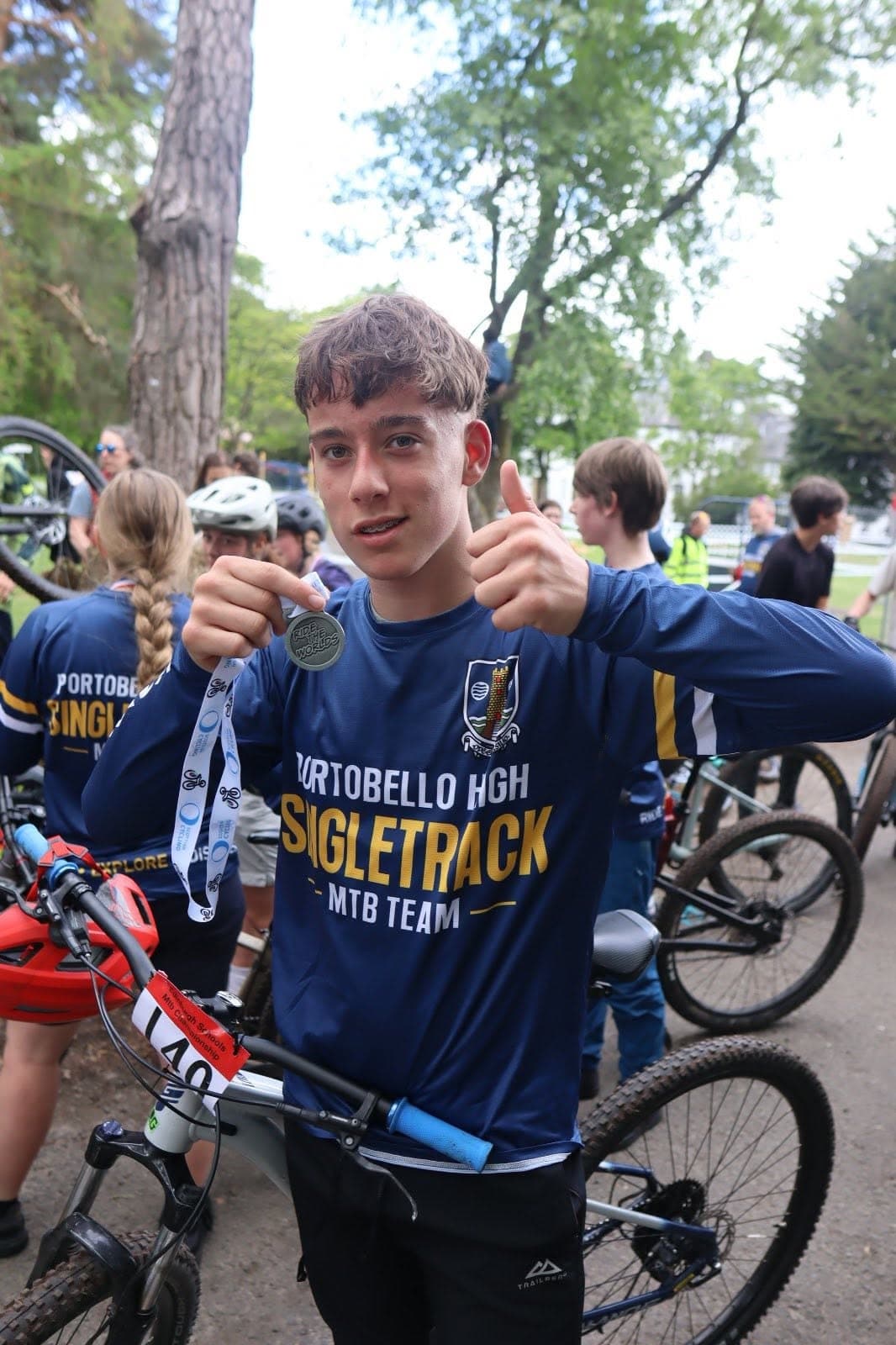 Mountain bike team rider sharing an award-winning moment in a custom jersey